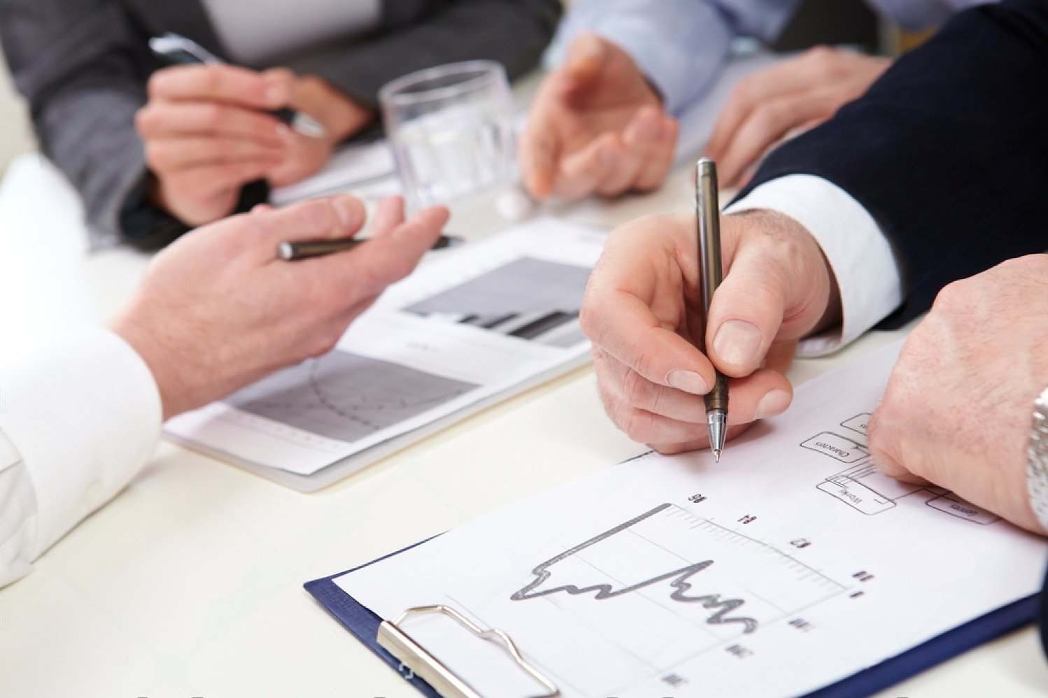 stock-photo-business-people-discussing-graphs-and-diagrams-95587402