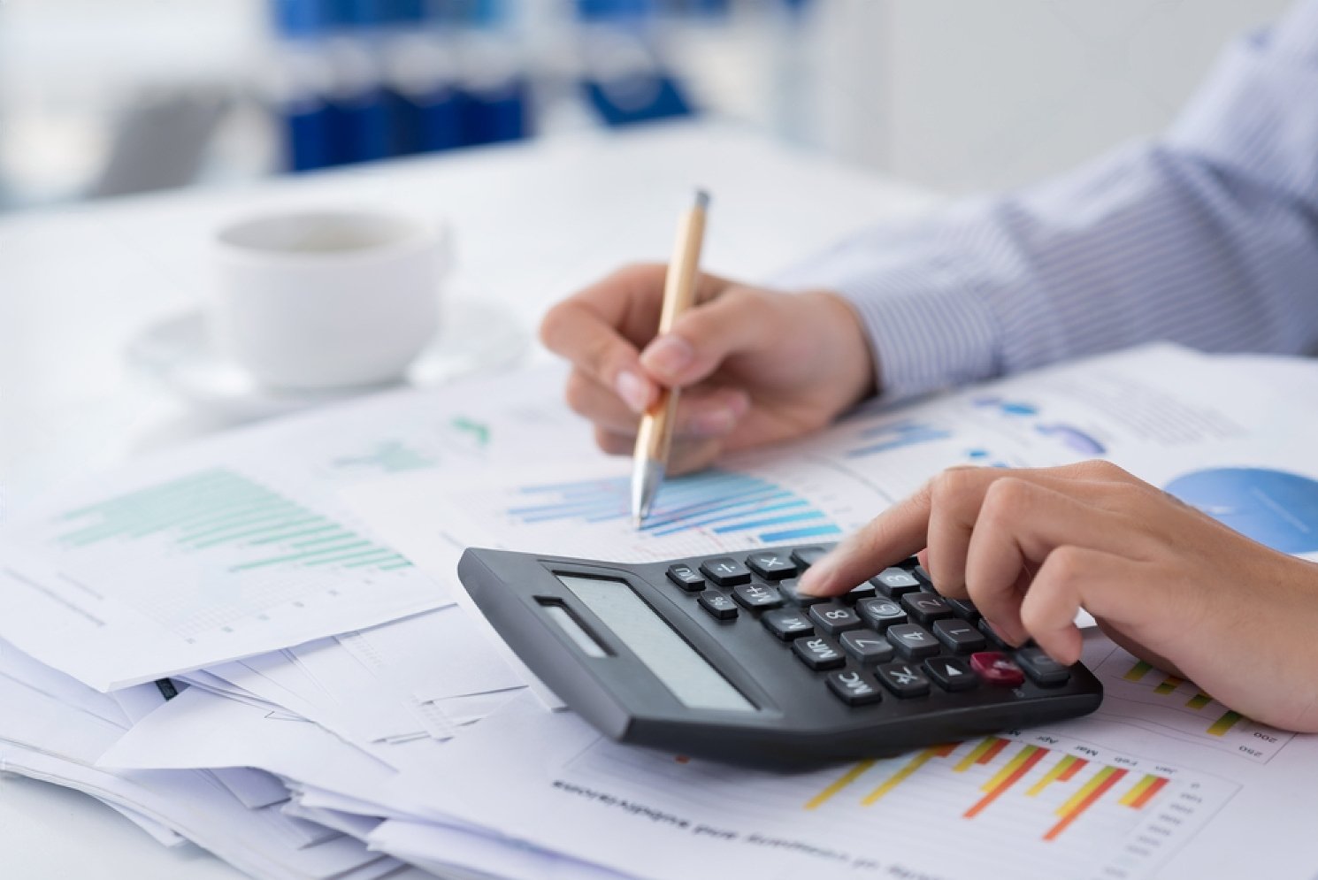 stock-photo-close-up-of-human-hands-working-with-a-calculator-on-the-foreground-153547994