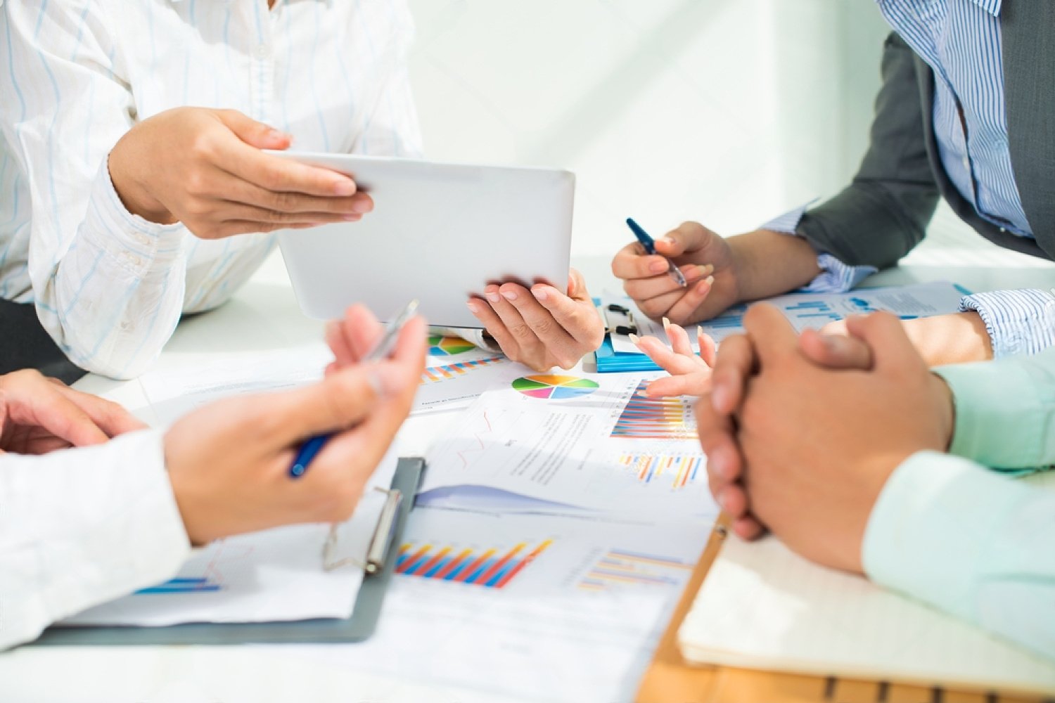 stock-photo-cropped-image-of-business-team-at-the-meeting-at-the-office-175323581